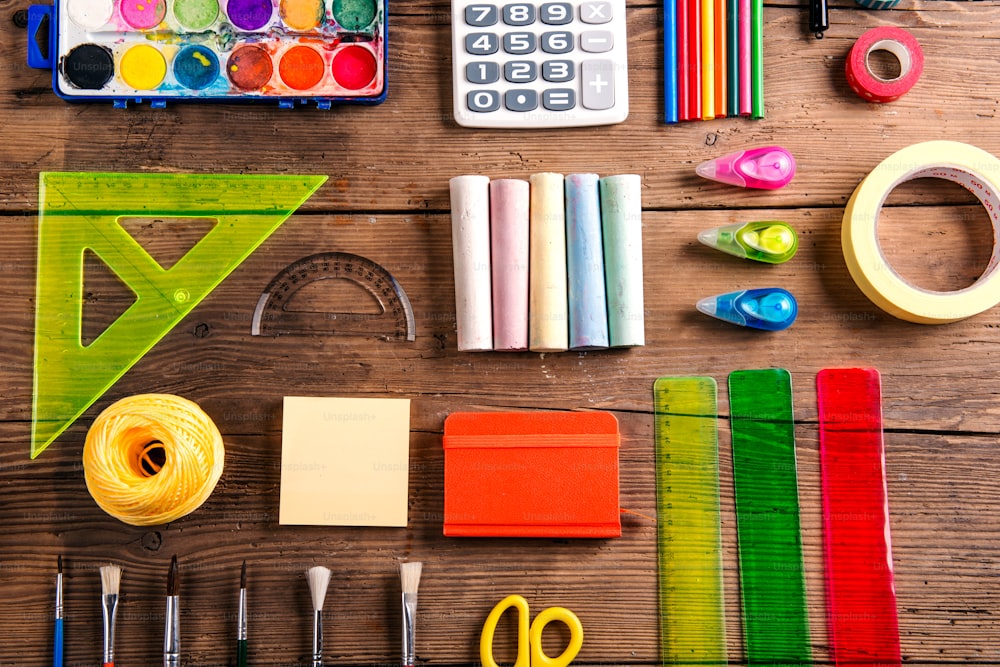 Desk with stationary. Studio shot on wooden background.