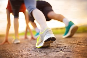 Runner couple feet preparing to run, closeup on shoes