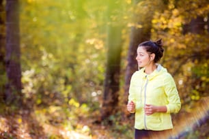 Young woman running outside in sunny nature