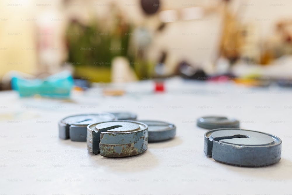 Close up of old rusty bobbin cases laid on table