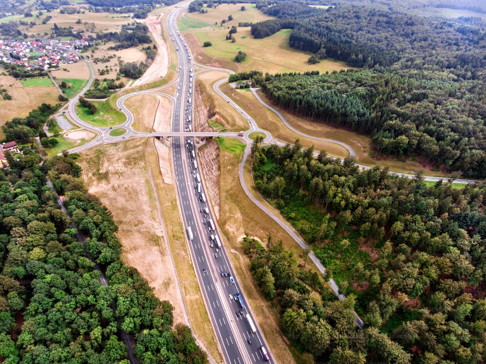 Aerial view of highway junction in the middle of green forest, traffic jam, Netherlands