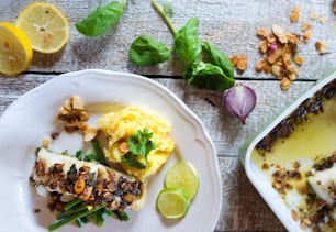 Zander fish fillet dish on a plate on white wooden table