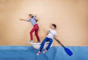 Joyful kids as sailors on the sea. Studio shot on a beige background.