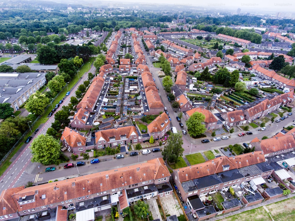 Aerial view of family houses with backyards in residential area of Dutch town