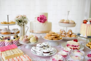 케이크, 컵 케이크, 쿠키 및 케이크 팝이 많은 테이블. 스튜디오 촬영.
