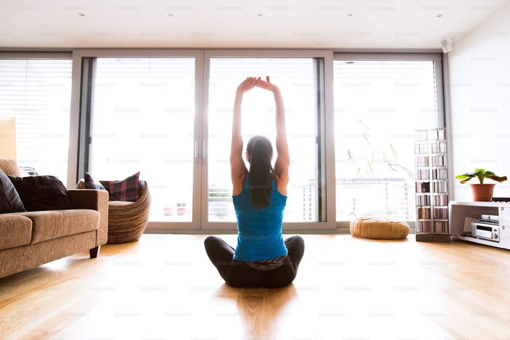 Premium Photo  A woman practicing yoga in a room with a window