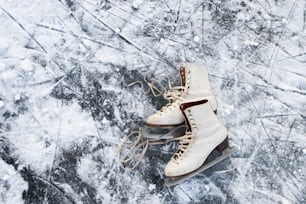 Old womans ice skates lying on the ice. Close up.