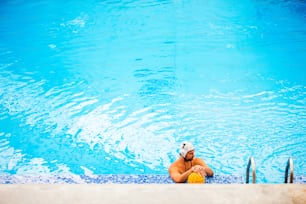 Water polo player in a swimming pool. Man doing sport.