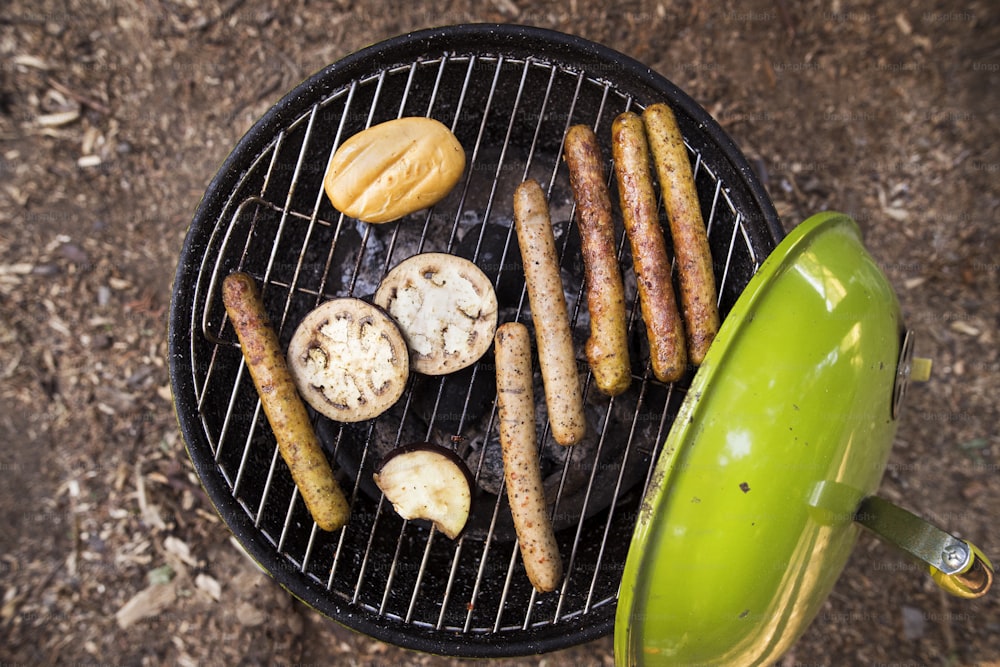 Barbecue grill with sausages, cheese and vegetables. Close up. Top view.