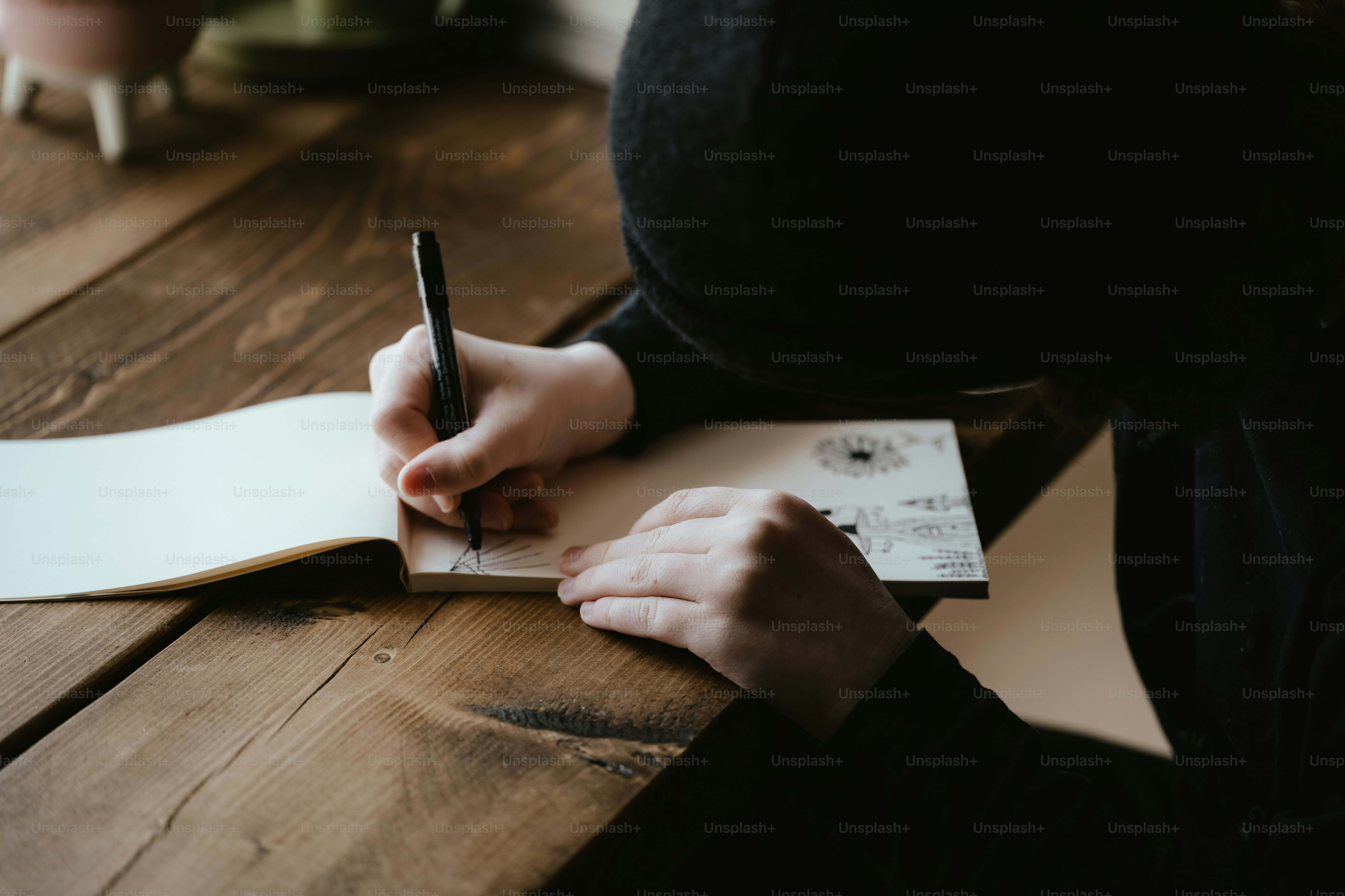 a person writing on a piece of paper