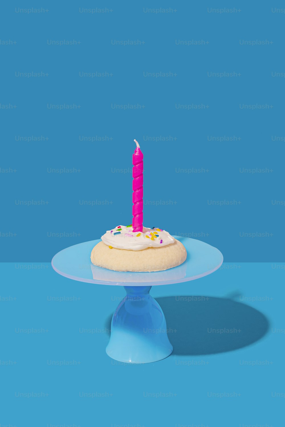 a birthday cake with a single candle on top of it