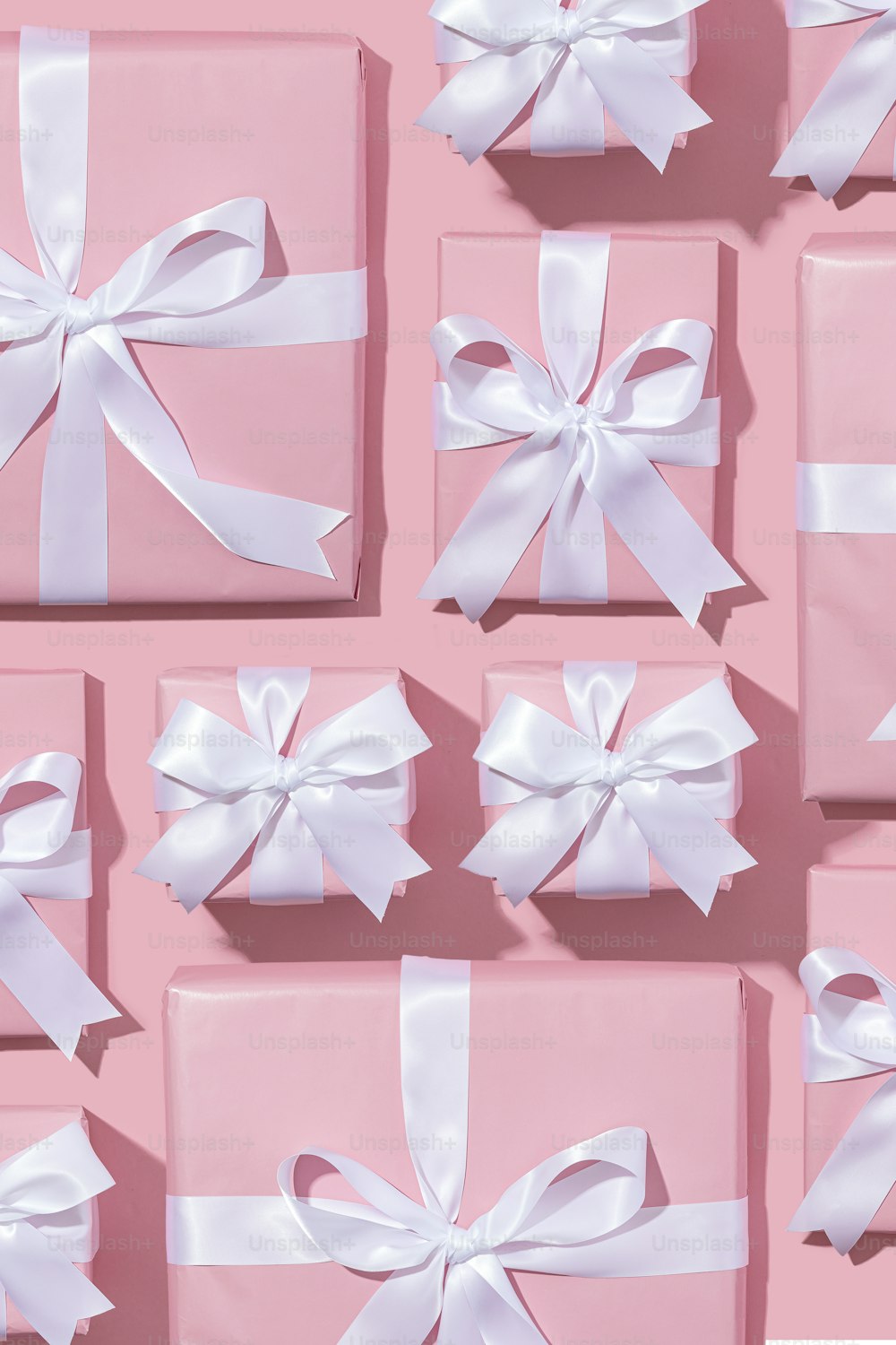 a group of pink boxes with white bows