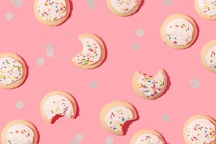 a pink background with lots of cookies and sprinkles