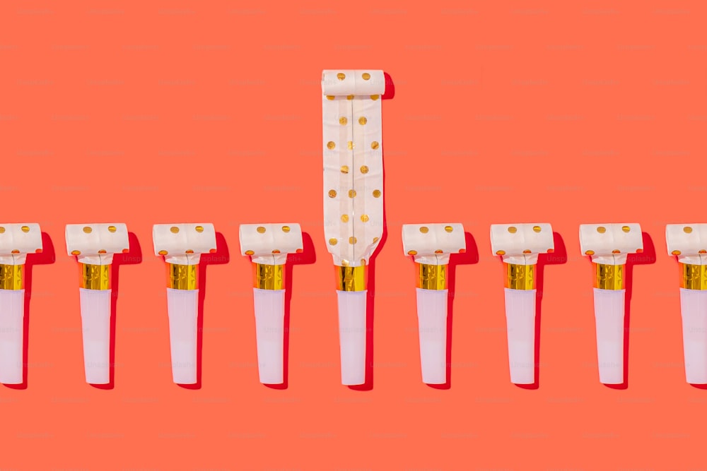 a row of white toothbrushes with gold tips