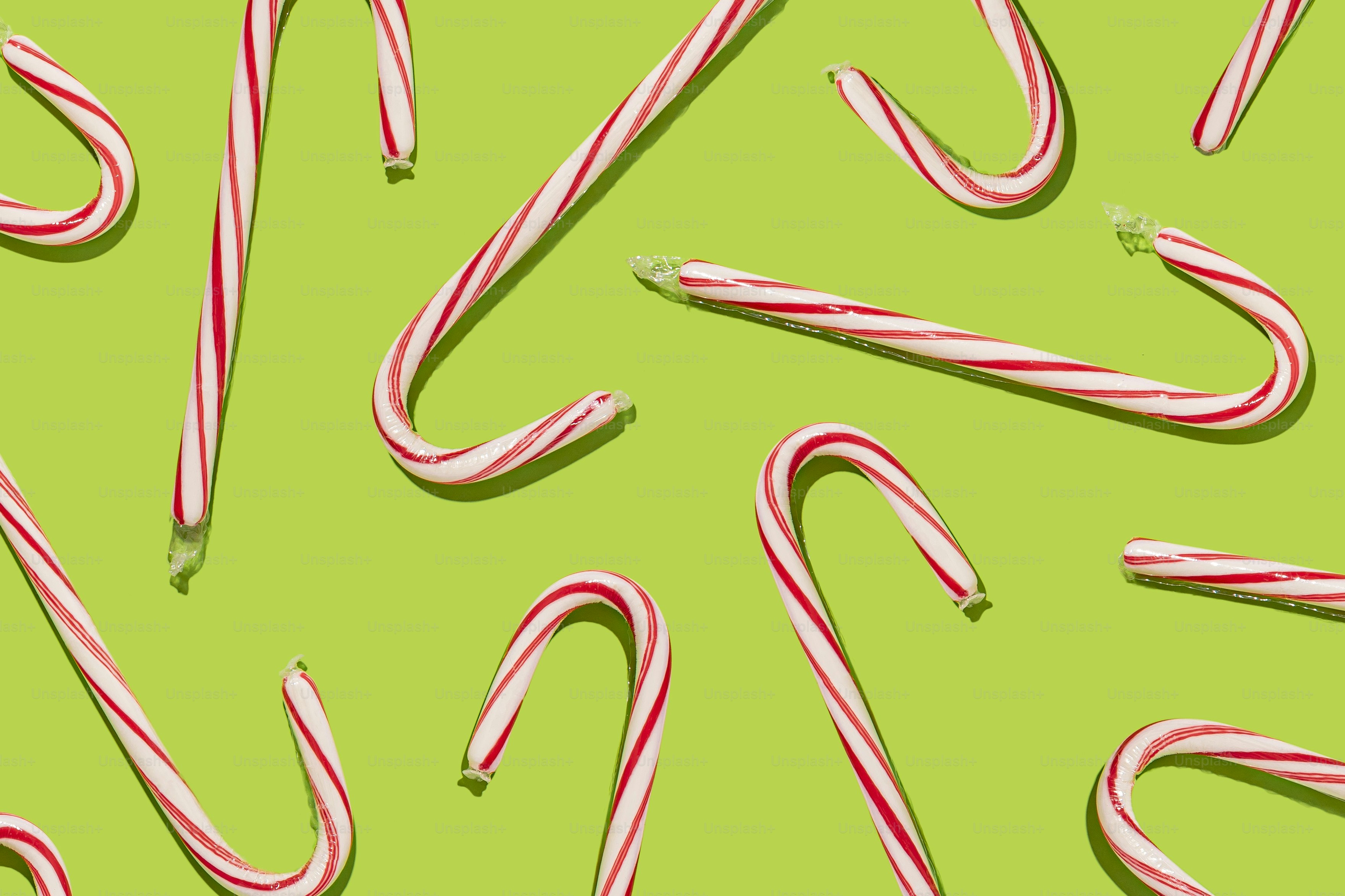 a group of candy canes on a green background