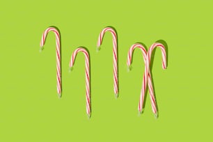 a group of candy canes on a green background
