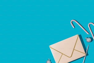 an envelope and candy canes on a blue background