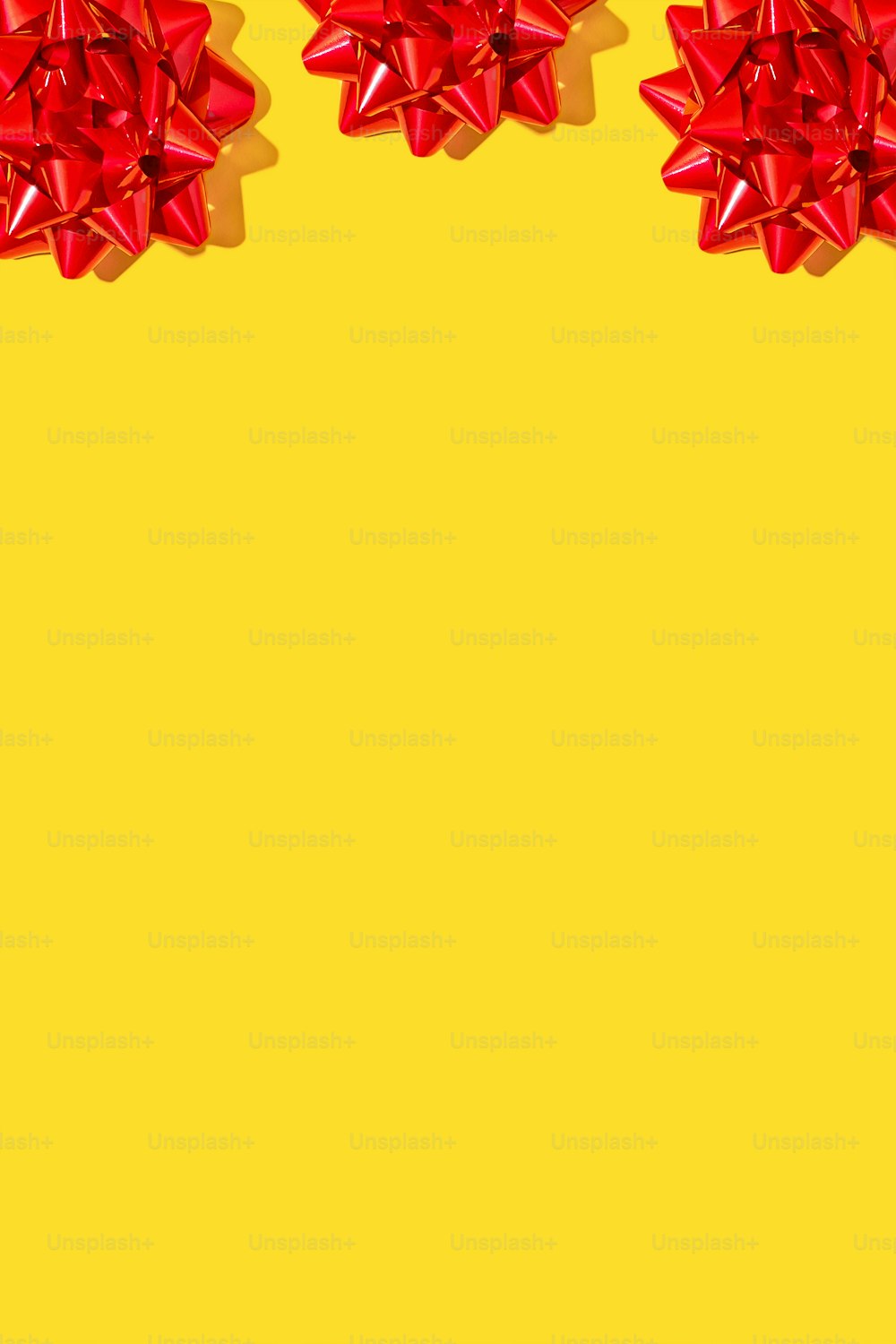 two red bows on a yellow background