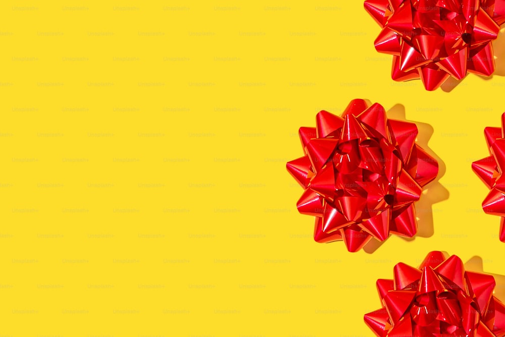 a group of red bows on a yellow background