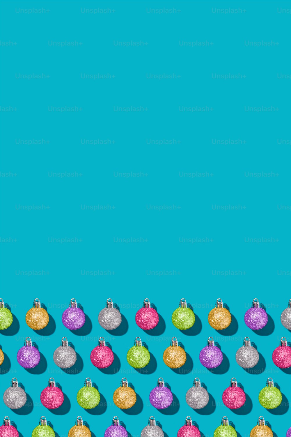 a row of christmas baubles on a blue background