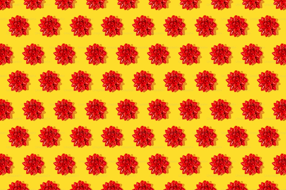 a pattern of red flowers on a yellow background
