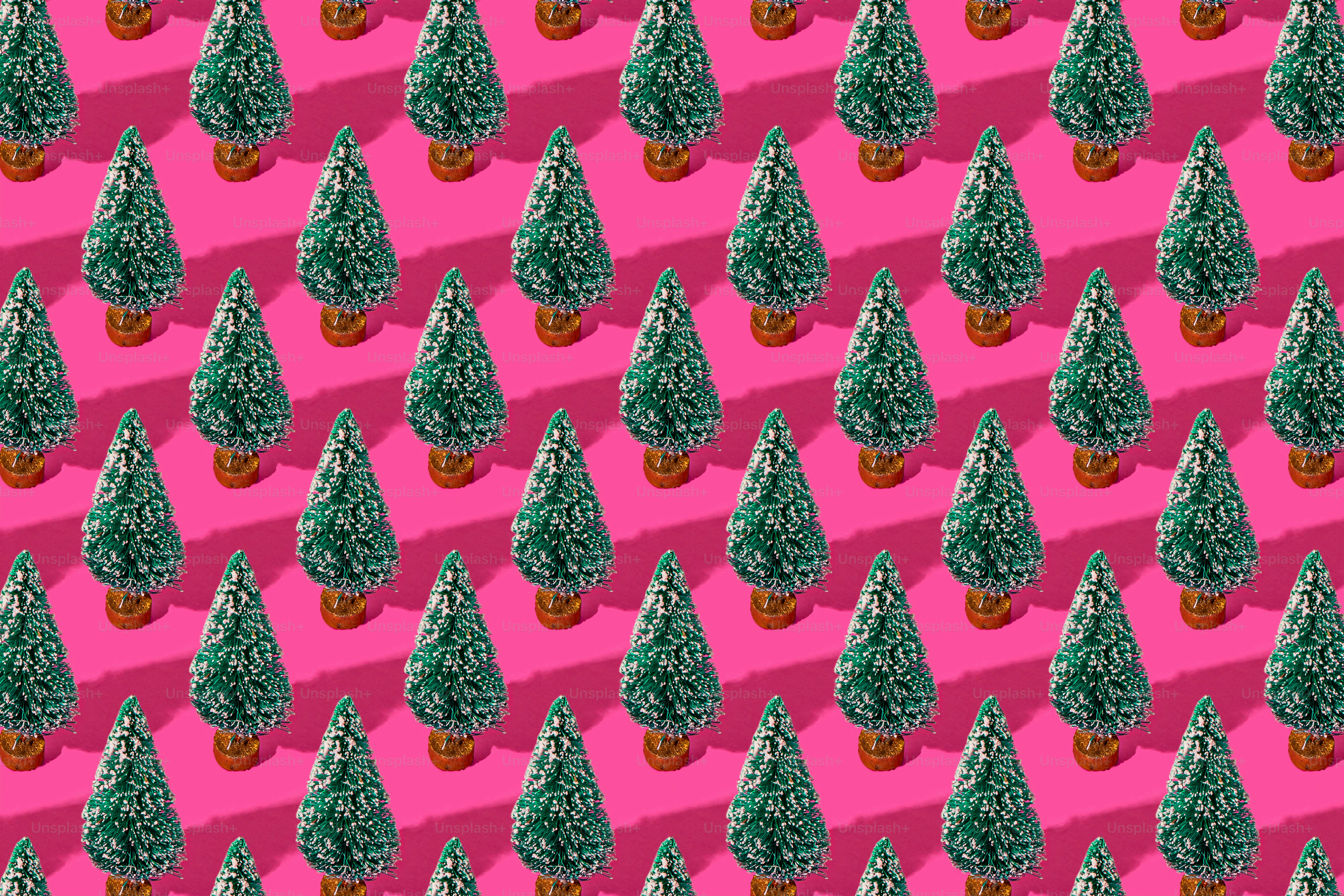a pattern of small trees on a pink background