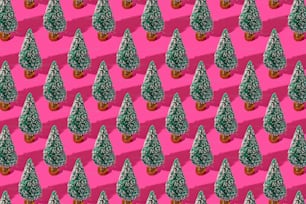 Ein Muster aus kleinen Bäumen auf rosa Hintergrund