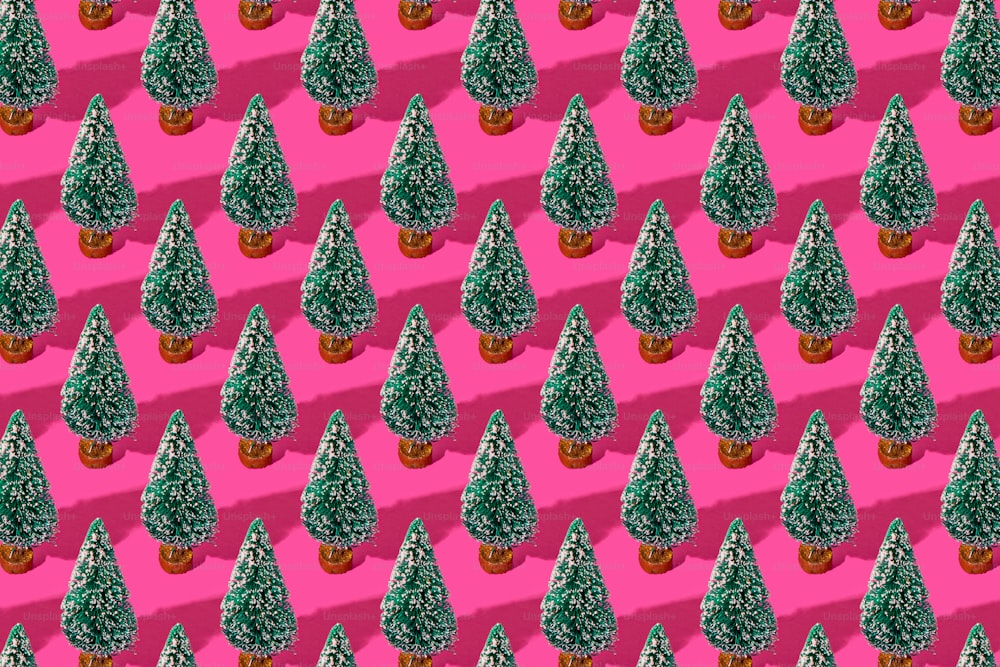 a pattern of small trees on a pink background