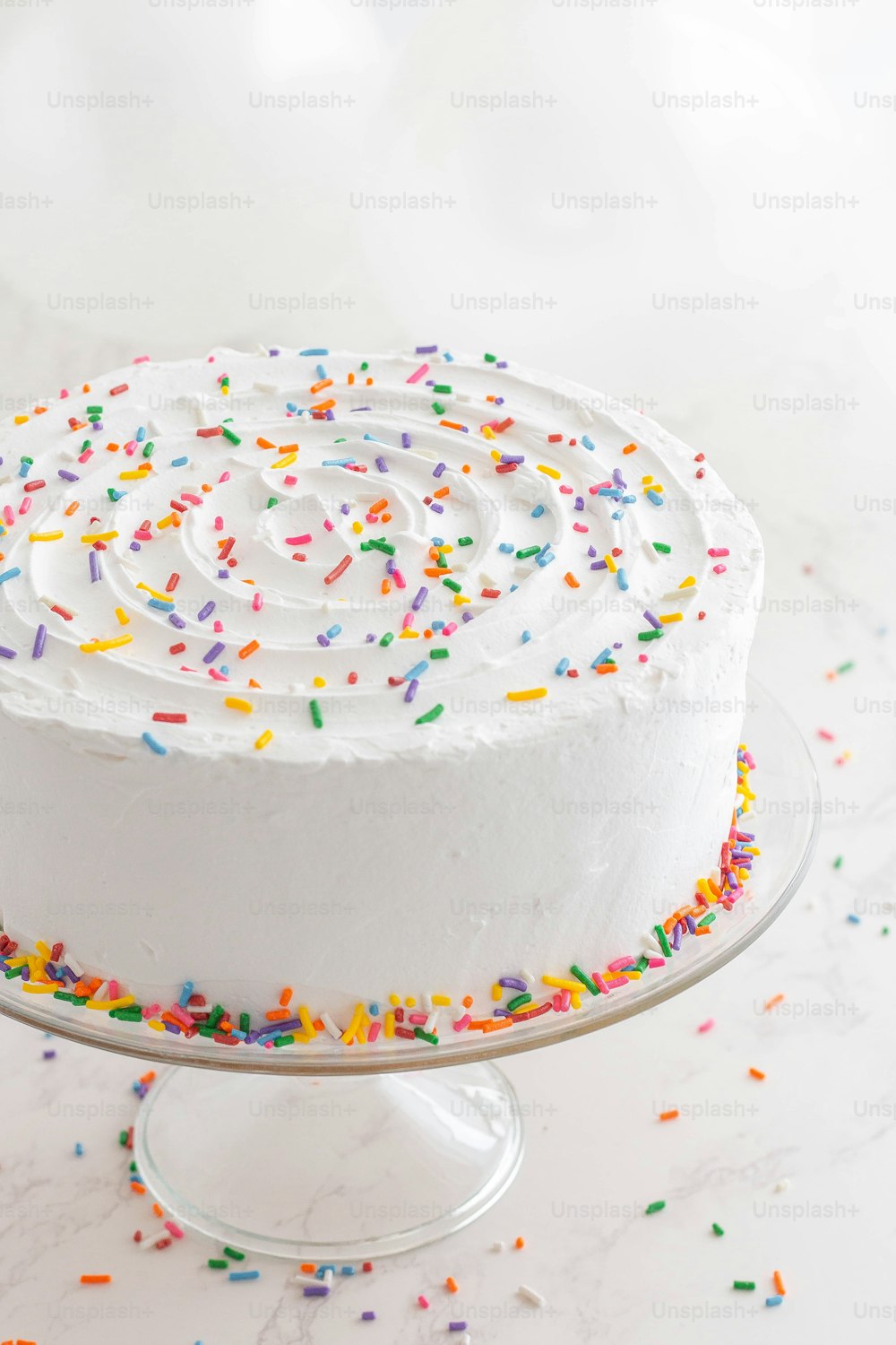 a cake with white frosting and sprinkles