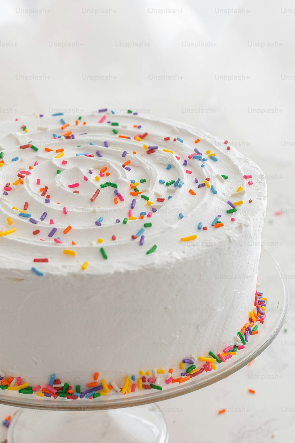 a cake with white frosting and sprinkles