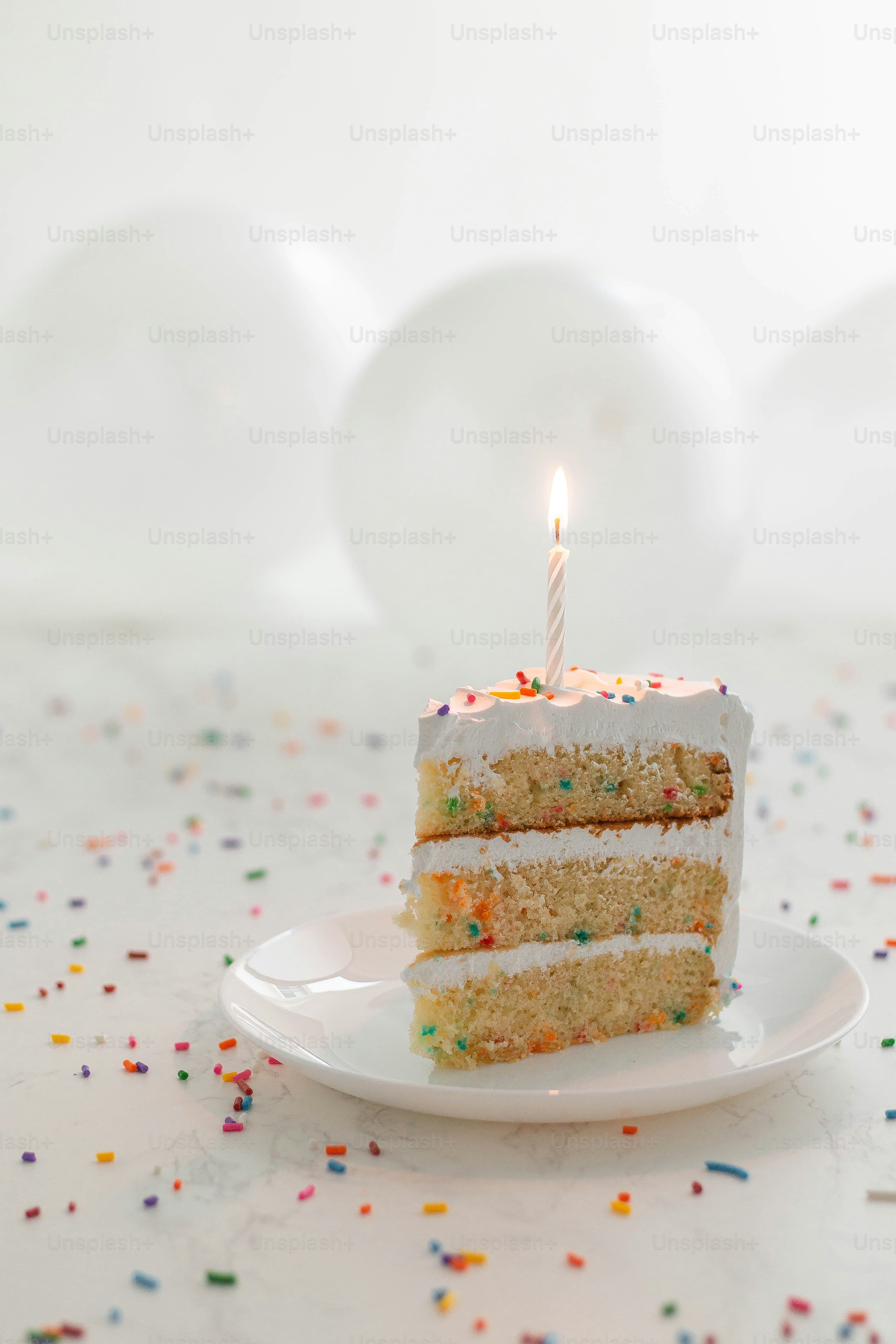 a slice of cake with a single candle on it