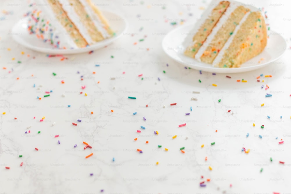 a white table topped with two slices of cake