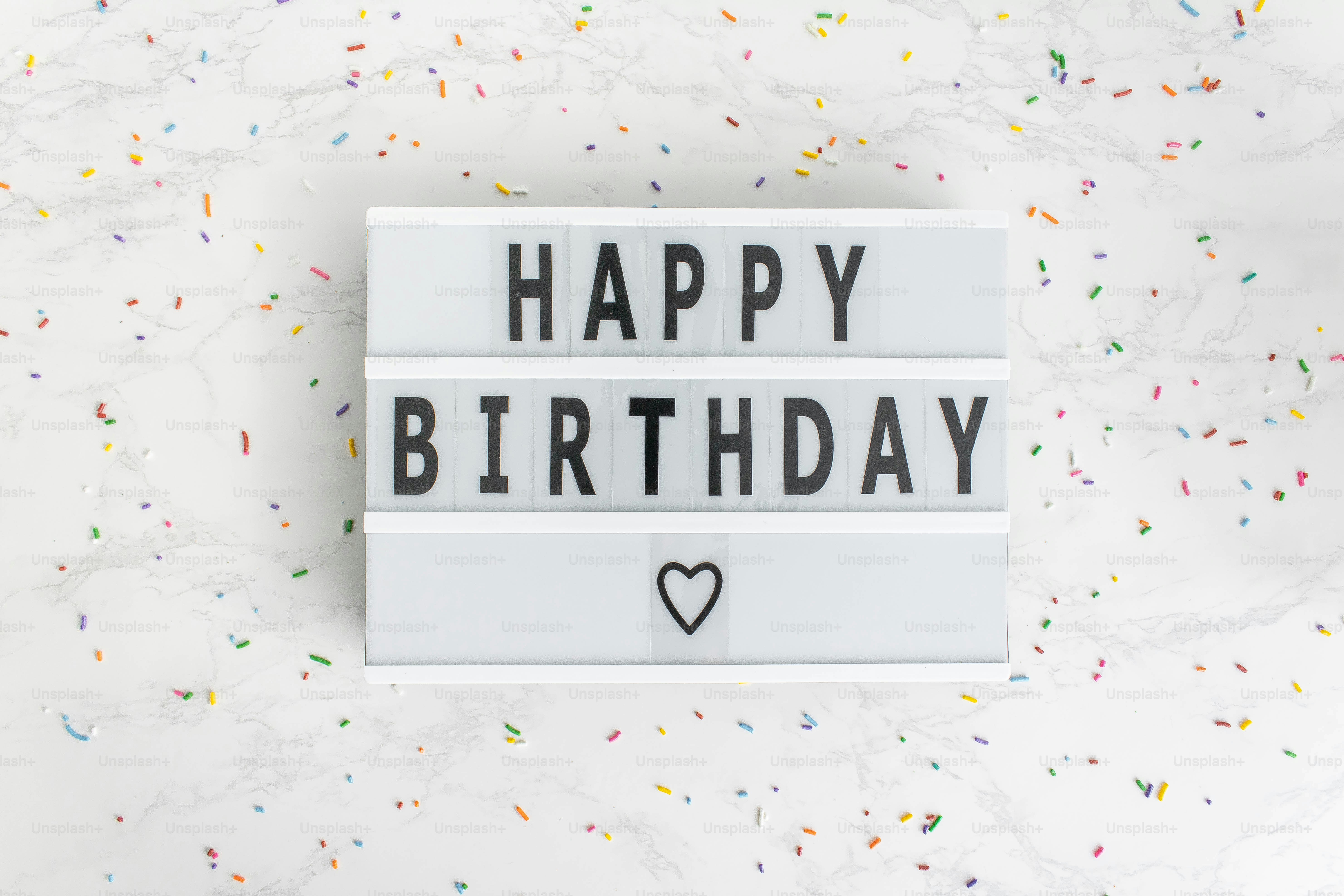 a happy birthday sign with a heart on it