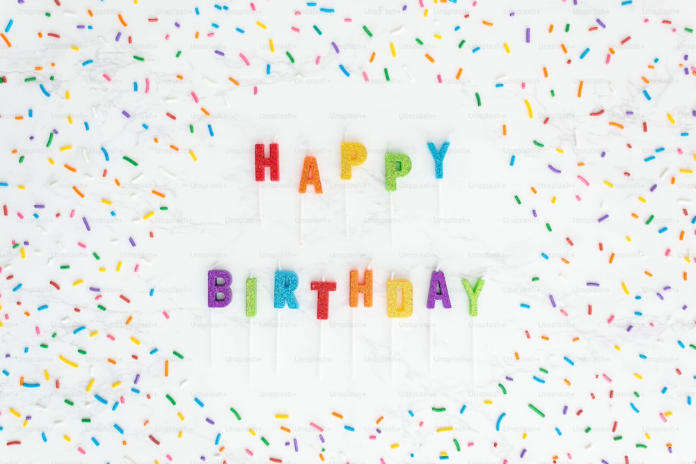 a happy birthday message made out of colored sprinkles