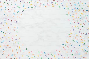 a white marble background with sprinkles of different colors