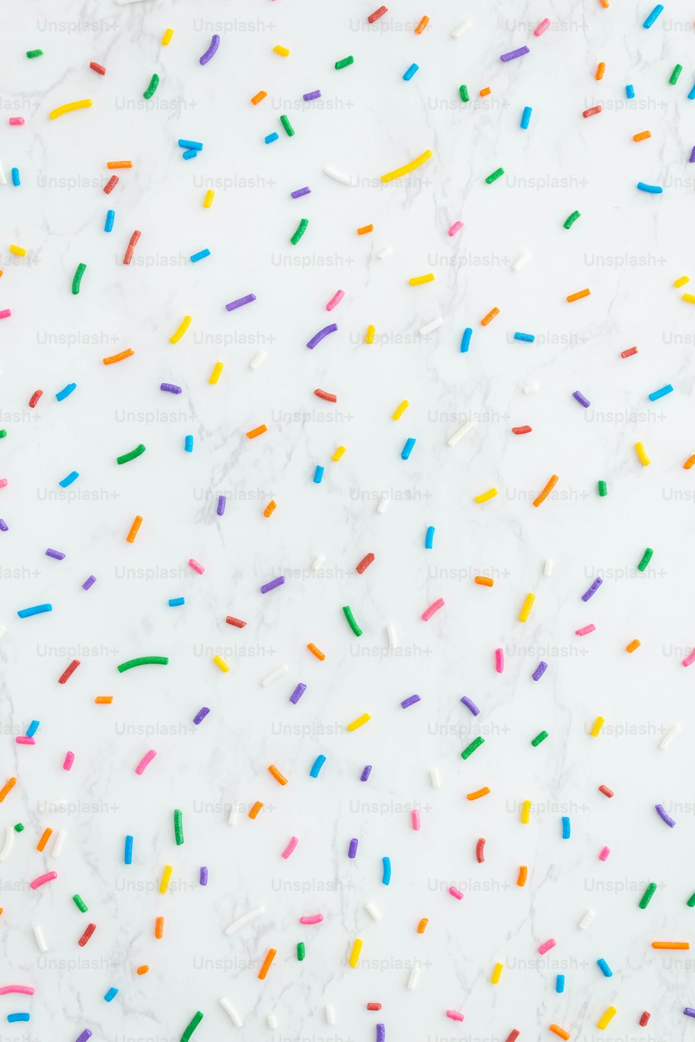 sprinkles on a white surface with a white background