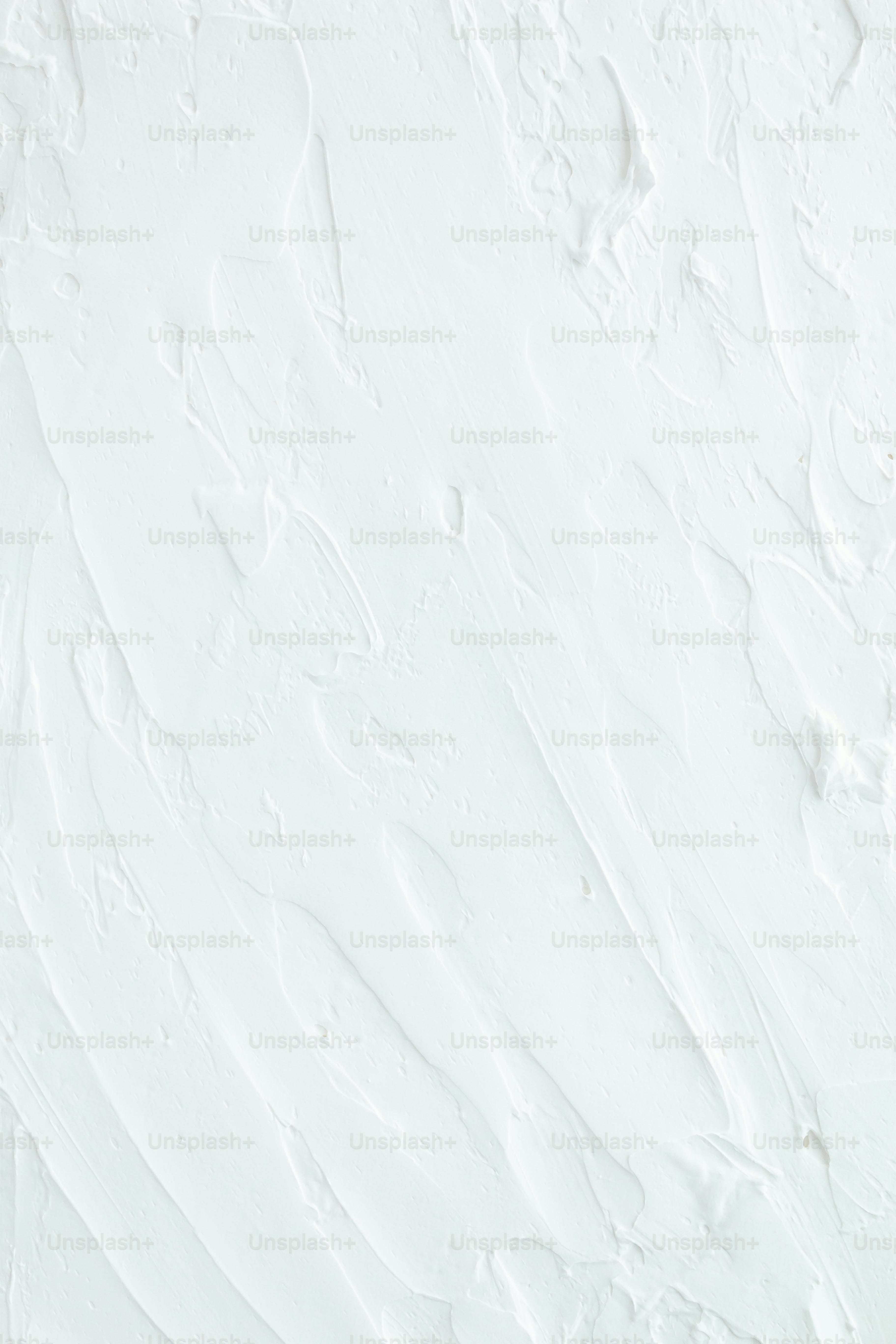 a snowboarder is going down a snowy hill