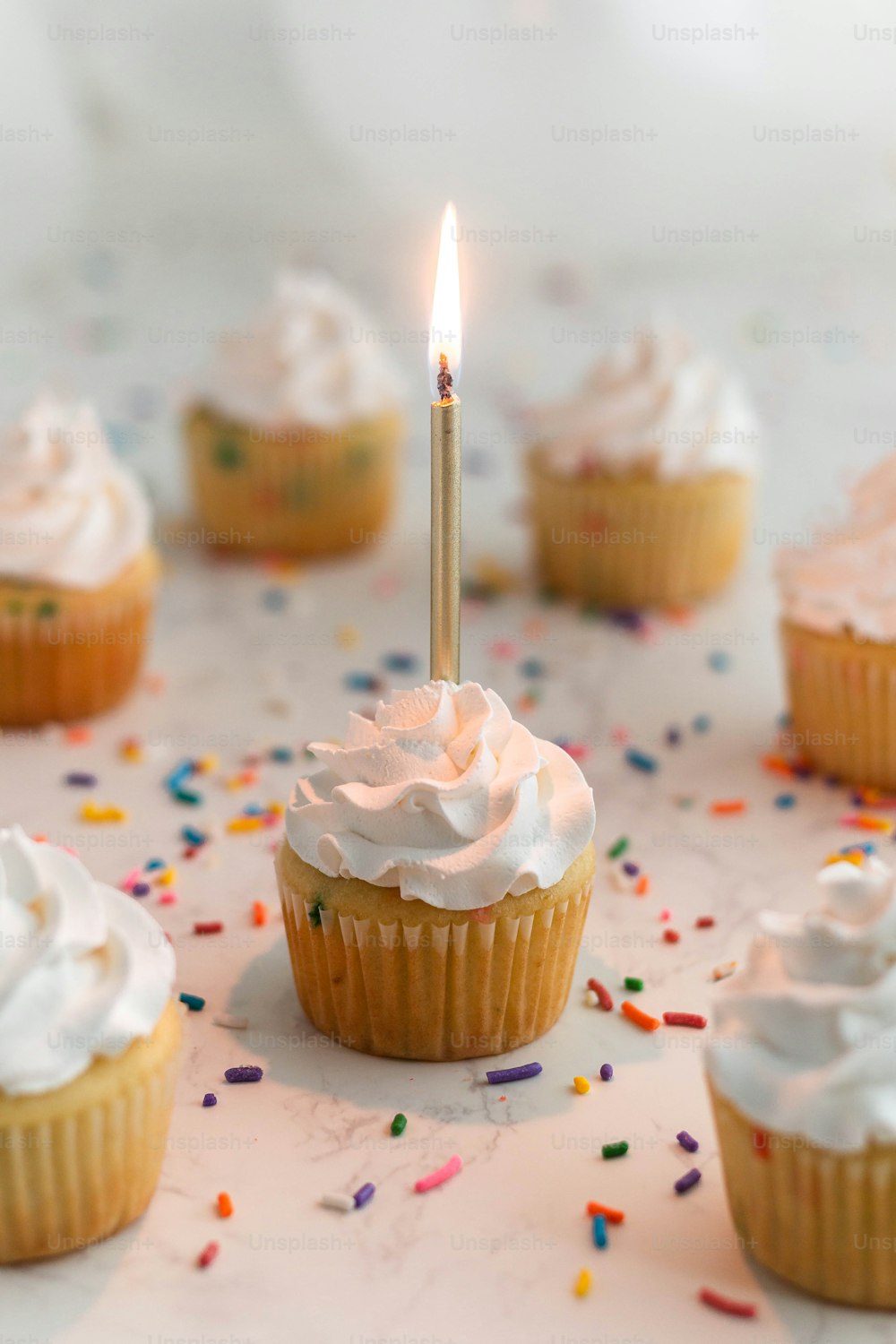 a cupcake with a single candle sticking out of it