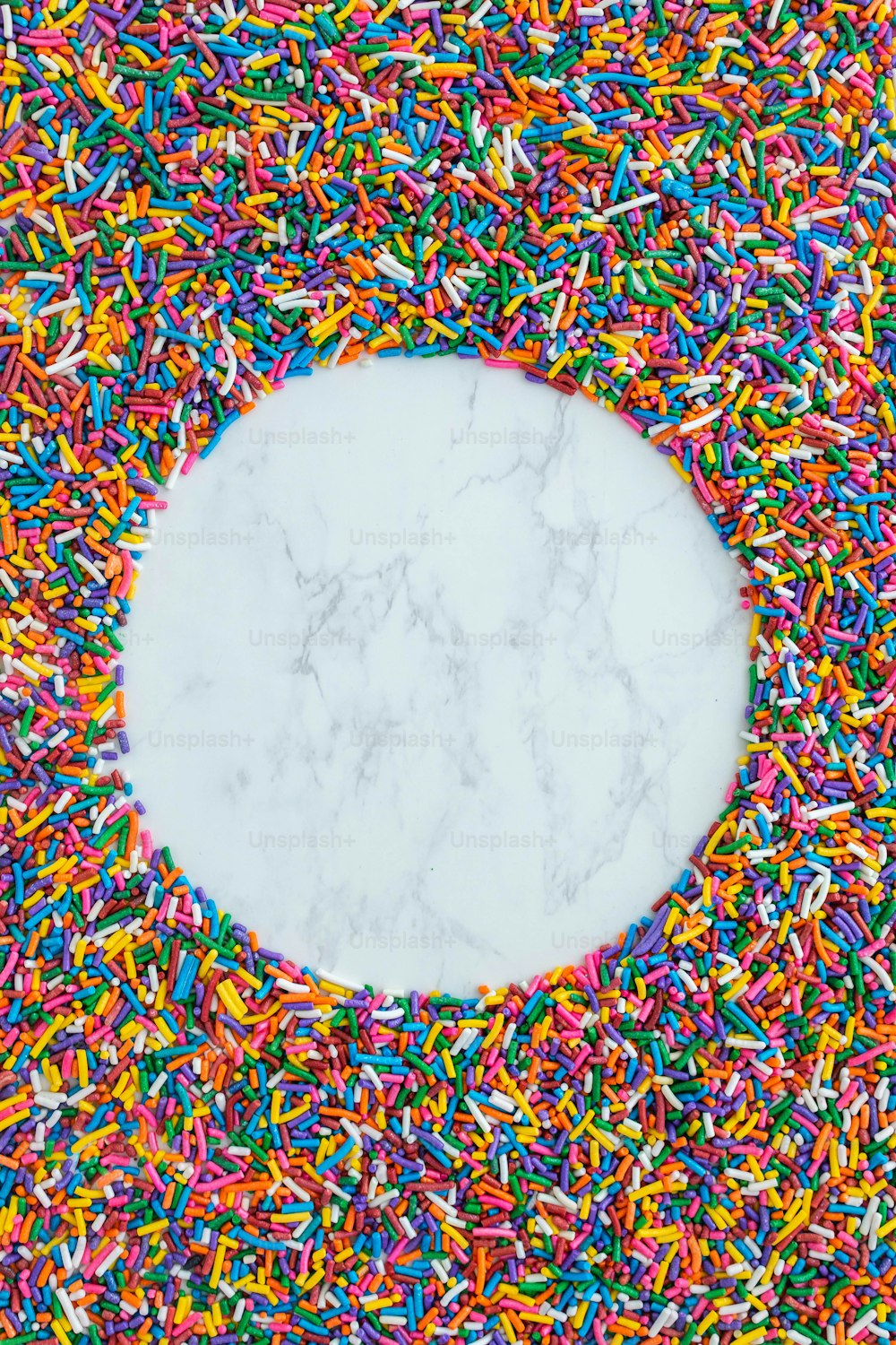 a white circle surrounded by colorful sprinkles