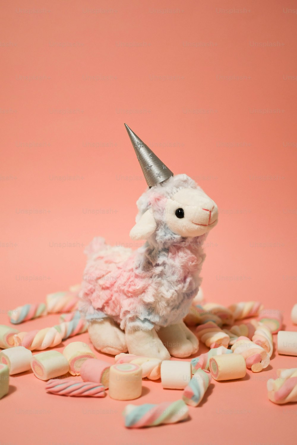 a stuffed animal with a horn on top of candy