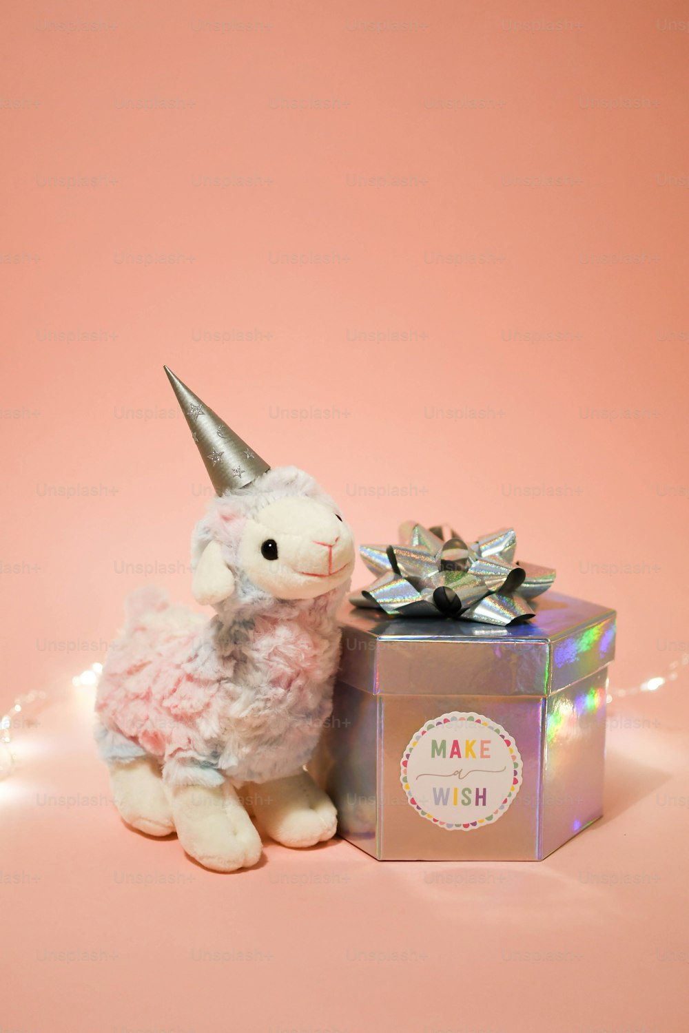 a stuffed animal sitting next to a gift box