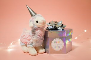 a stuffed animal next to a gift box