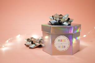 a small gift box with a bow on top of it