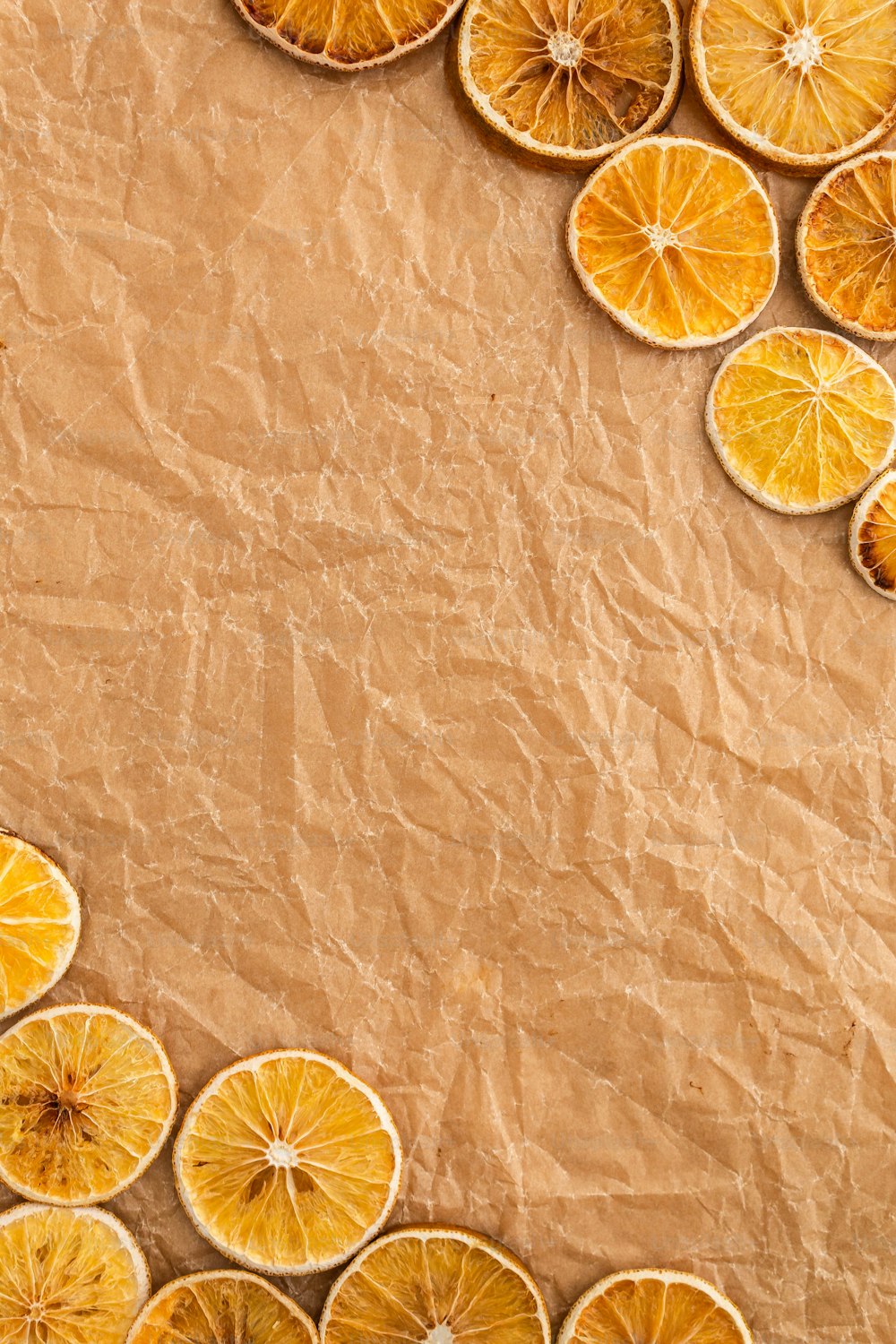 a bunch of orange slices on a piece of brown paper