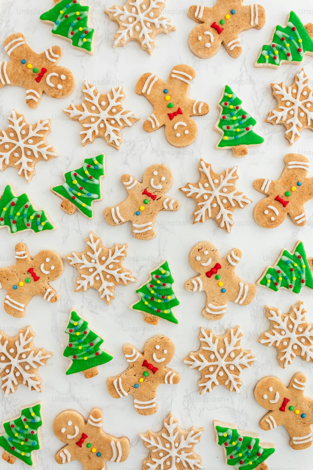 a table topped with lots of decorated cookies