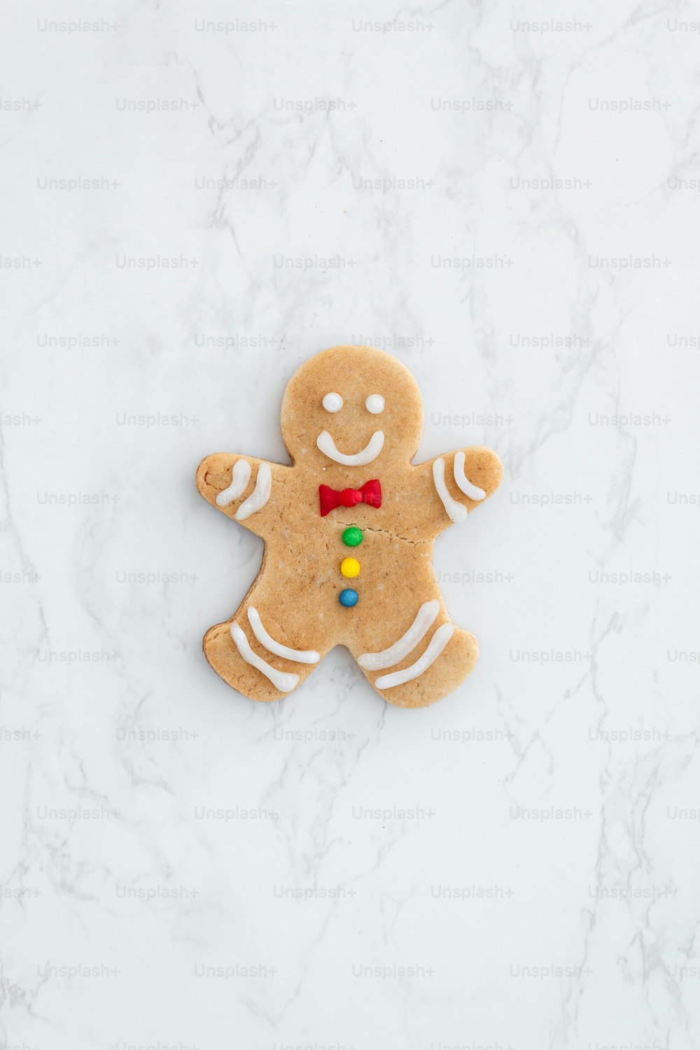 a cookie shaped like a ginger with a bow tie