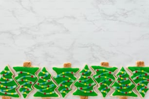 a row of decorated cookies with christmas trees on them