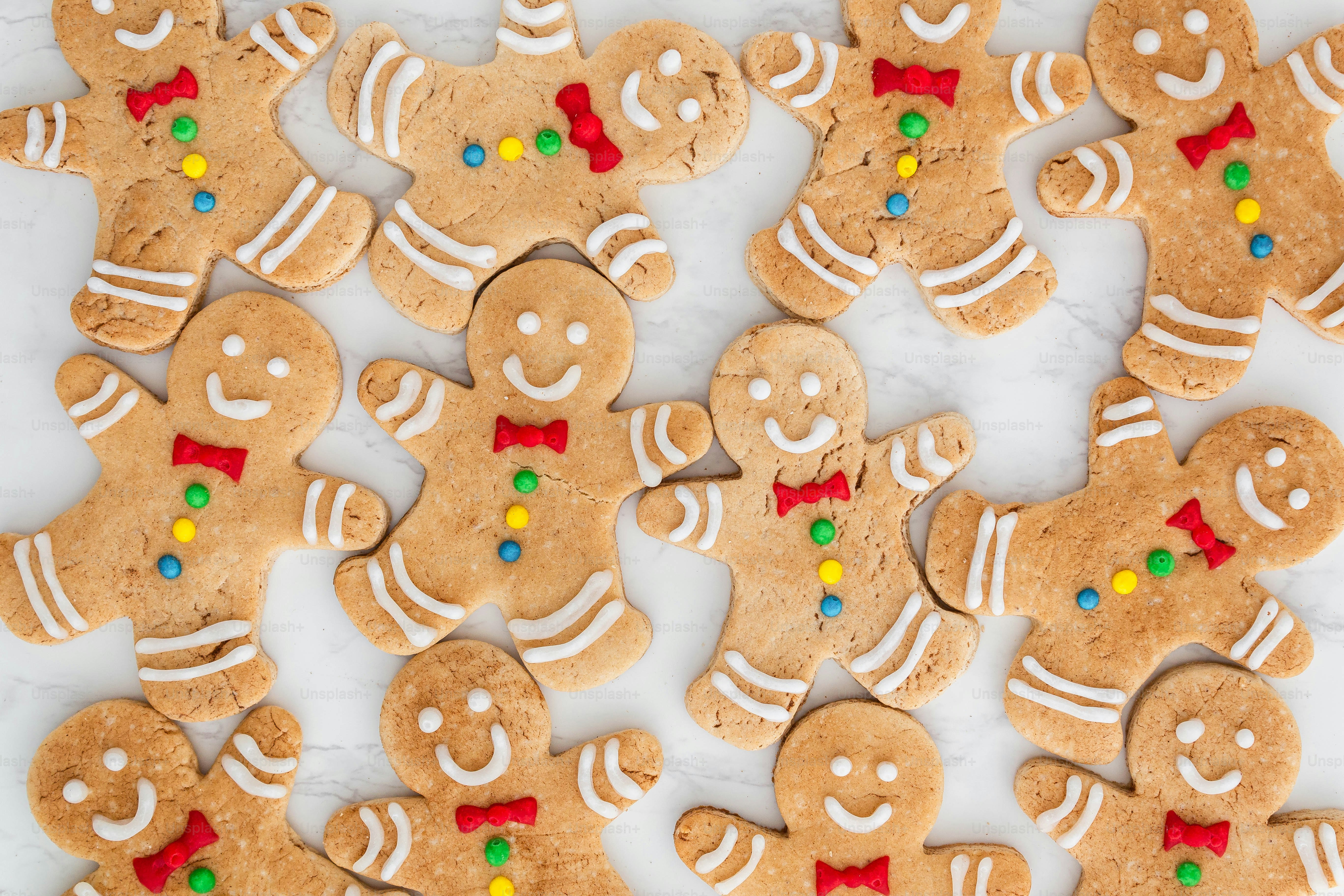 a table topped with lots of cookies covered in icing