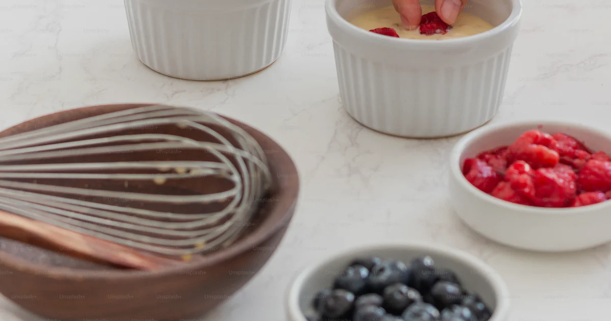 Mixing Ingredients Example A person mixing ingredients in bowls on a table photo – Food Image on ...