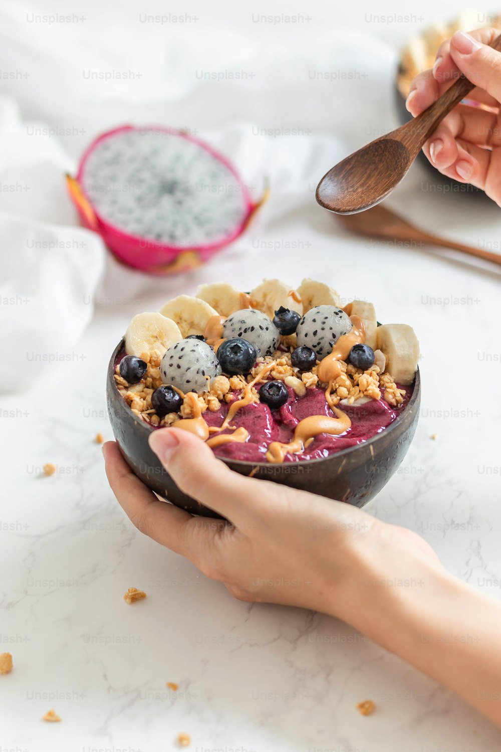 a person holding a bowl of fruit and cereal